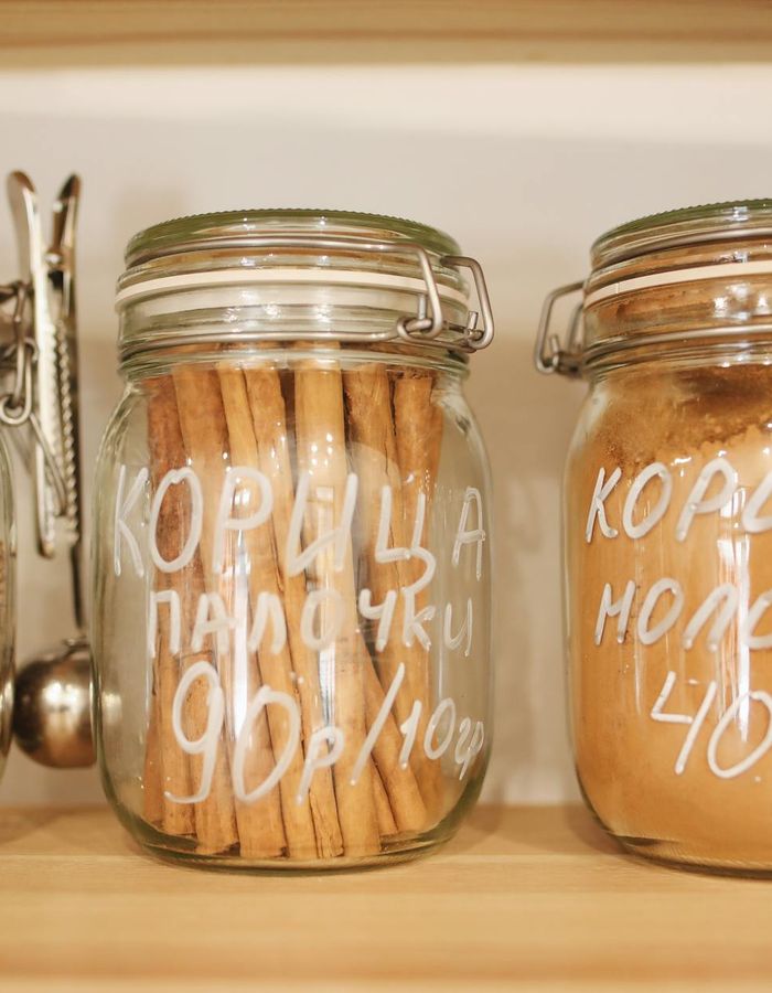 Fresh green herbs in a glass container for joint support